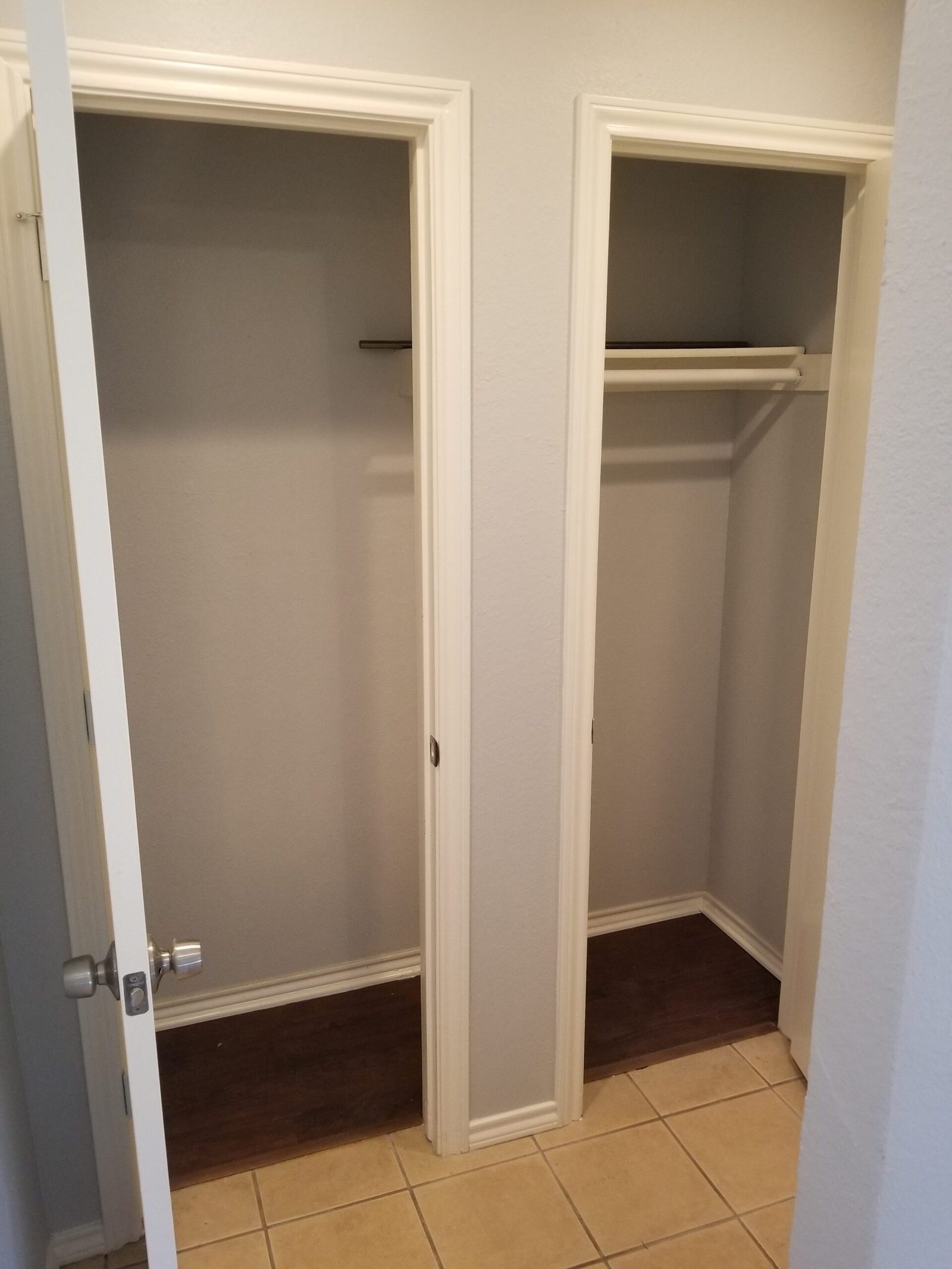 Double hall storage closet with hanging rails