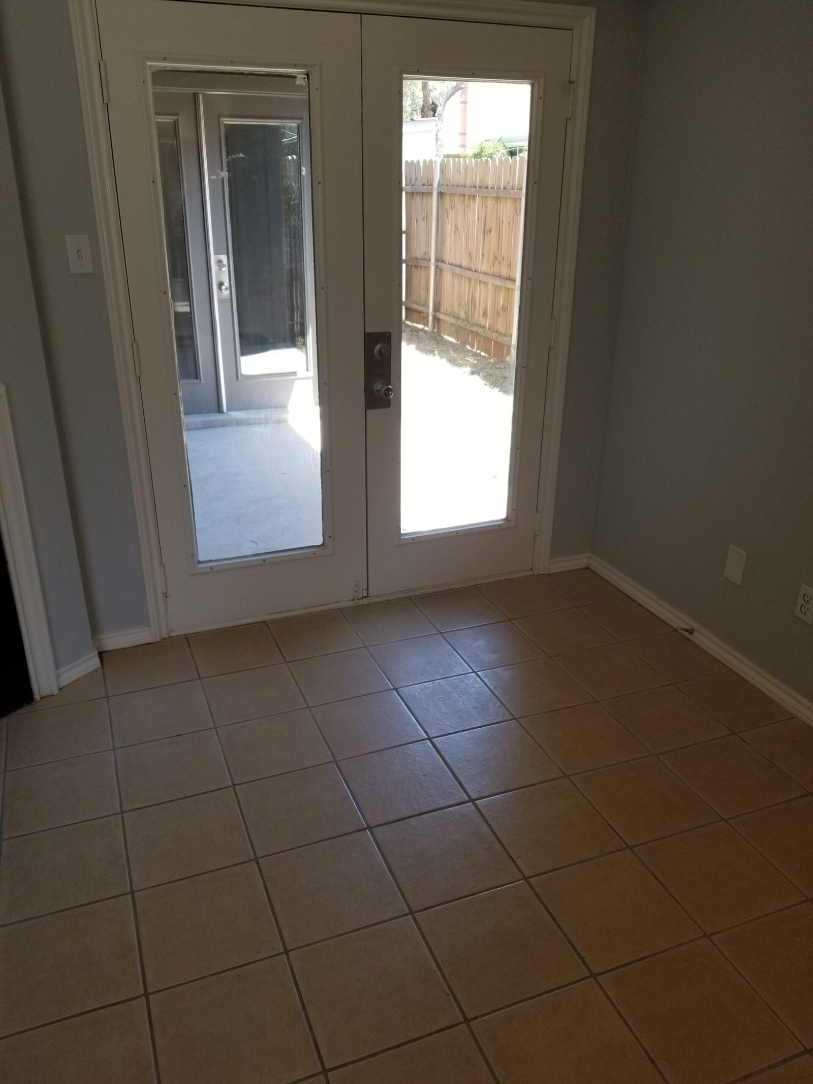 French doors opening from the unit onto the private fenced patio