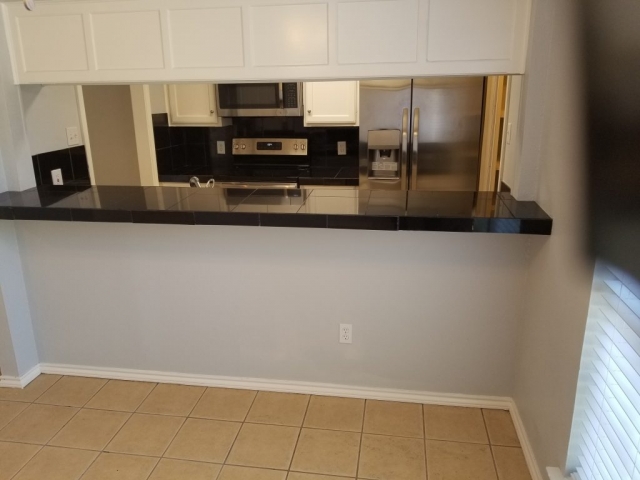 KITCHEN BREAKFAST BAR AND LIVING ROOM